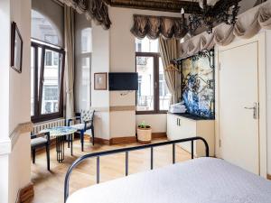 a bedroom with a bed and a table and chairs at Ragip Pasha Apartments in Istanbul