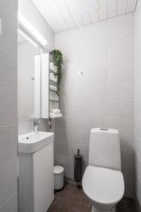 a white bathroom with a toilet and a sink at "PENTHOUSE" - Renovated 1BR Apt with Sauna & 60m2 Private Terrace, Hosted by 2ndhomes in Tampere +19 photos