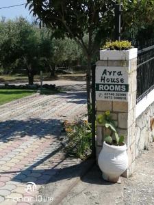 an art house rooms sign on a brick sidewalk at Avra Ηouse in Kriopigi