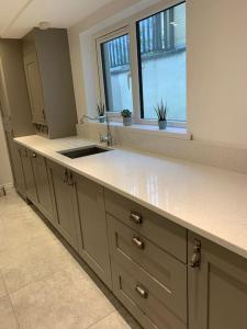 a large kitchen with a sink and a window at No. 22 in Derry Londonderry +23 photos