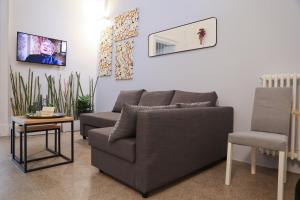 Nice House San Biagio - Luxury Full Apartment في ليتشي: غرفة معيشة مع أريكة وكرسي