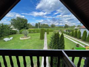 a view of a garden from a balcony at Wooden House in Podgorica