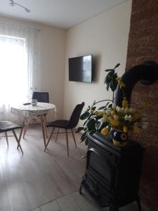 a living room with a stove and a table with chairs at LIUX apartamentai in Kaunas