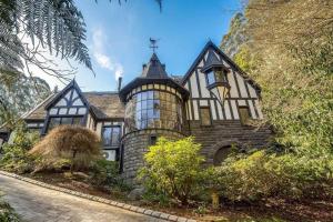 an old house with a turret on the side of it at Fernhill Estate “ Gingerbread House” in Kallista