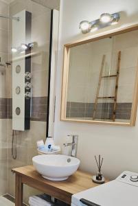 a bathroom with a white sink and a shower at Suite Villanova Near Disneyland Paris in Chessy