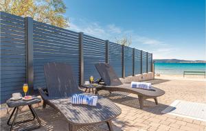 a patio with two chairs and a table with drinks at Stunning Home In Sibenik - Zaboric in Zaboric +37 photos