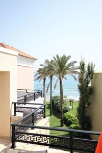a view of the beach from the balcony of a house at Alexandra Beach Hotel in Nea Kydonia