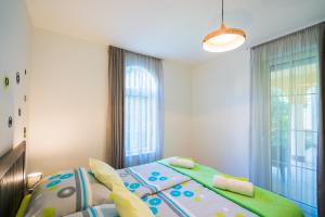 Posteľ alebo postele v izbe v ubytovaní Phoenix Apartman Siófok
