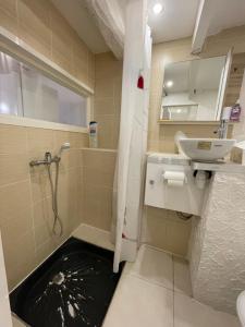 a bathroom with a sink and a shower with a hole in the floor at La Garde Studio centre historique, proche plage, climatisation, fibre in La Garde