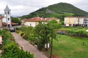 a small town with a church and a hill at Altamira, SEA & MOUNTAIN in Busturia