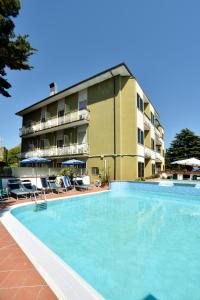 a large swimming pool in front of a hotel at Hotel Diano Marina Mhotelsgroup in Diano Marina