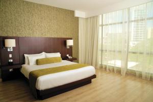 a bedroom with a large bed and a large window at Best Western Plus Panama Zen Hotel in Panama City +103 photos