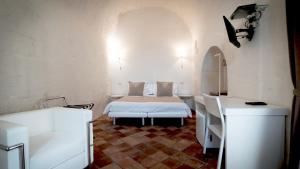 A bed or beds in a room at Giardini di Pietra