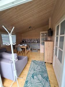 a living room with a couch and a table at Domki Przy Marinie Wapnica 6 km od Międzyzdrojów in Wapnica
