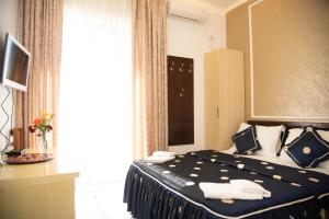 Postel nebo postele na pokoji v ubytování Elite Hotel