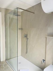 a shower with a glass door in a bathroom at Locanda del Glicine in Campagnatico
