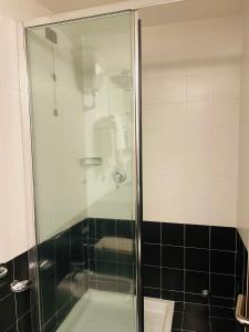 a shower with a glass door in a bathroom at Locanda del Glicine in Campagnatico