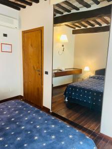 Posteľ alebo postele v izbe v ubytovaní Locanda del Glicine