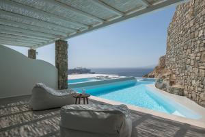 a pool with a view of the ocean from a villa at Arocaria Mykonos in Mýkonos City