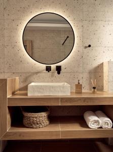 a bathroom with a sink and a mirror at Margie Sea View Apartment in Zakynthos