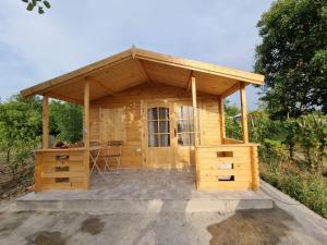 a wooden shed with a table in it at Rost Village Maciuca in Ciocănari
