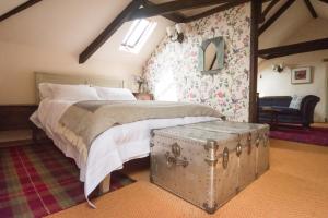 A bed or beds in a room at Lower Severalls Farmhouse