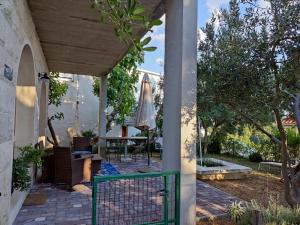 a patio with a table and an umbrella at Holiday Home with free parking by the beach in Brela