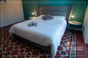 a bedroom with a bed with two towels on it at Villa Gaffurio in Bergamo