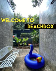 a backyard with a blue inflatable bird bath next to a bench at BeachBox@Koh Сhang in Ko Chang
