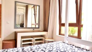 a bedroom with a bed and a mirror at Lovely 1BD Apartment in a Luxury Resort in Sozopol in Sozopol