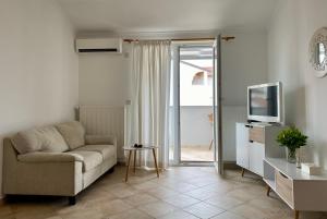 a living room with a couch and a television at Villa Adria in Vodice