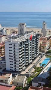 a large white building next to the ocean at Apartamento Justina 2 in Los Mártires