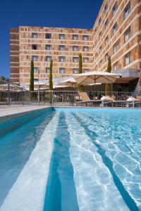 a swimming pool in front of a hotel at Sercotel Valladolid in Valladolid