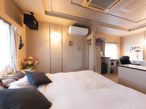Postel nebo postele na pokoji v ubytování Tabist Hotel Nizi Fuefuki Misaka