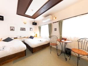 Postel nebo postele na pokoji v ubytování Tabist Hotel Nizi Fuefuki Misaka