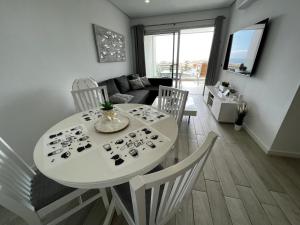 A television and/or entertainment centre at Ocean Garden Sunset Apartment - heated swimming pool Free WIFI
