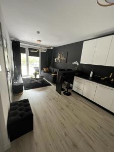 a living room with a couch and a table at Black Amber in Władysławowo