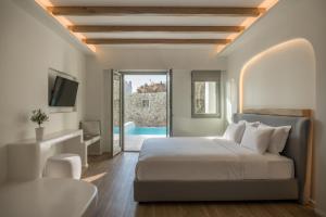 Postel nebo postele na pokoji v ubytování Arocaria Mykonos