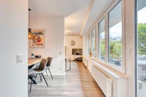 a hallway with a table and chairs and windows at Haus Kleemann E24 in Norderney