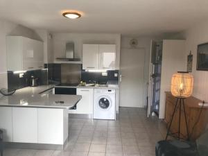 a kitchen with a washing machine and a washer at CORTADERIA B002 in Saint-Cyprien +5 photos