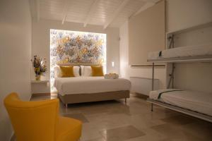 a bedroom with two bunk beds and a window at Otto Apulia House B&B in Andria