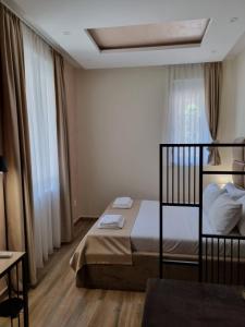 a bedroom with a bed and a window at Up Hostel in Belgrade