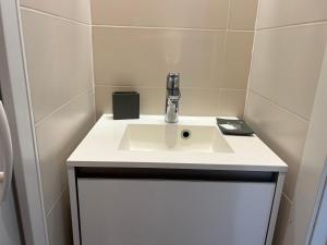 a bathroom with a sink with a faucet at Génépis - Studio rénové Tignes Val Claret 4 pax in Tignes
