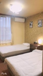 En eller flere senge i et værelse på ホテルルネサンス土浦