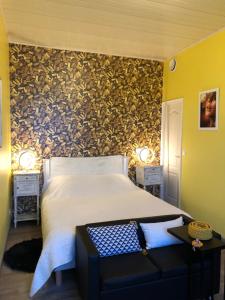 a bedroom with a large bed and a wall with a accent at Domaine de l'île - Gîtes et chambres d'hôtes in Castelsarrasin +18 photos