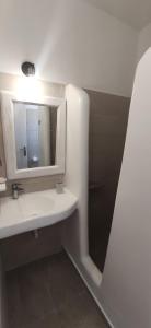 a bathroom with a white sink and a mirror at Nora Norita in Batsi