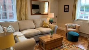 a living room with a couch and a table at Oulton Park Lodge in Little Budworth
