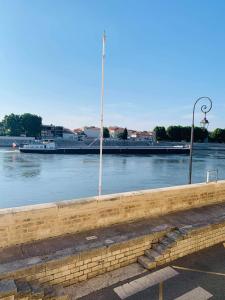 a view of a river with a boat in the water at Sur les quais... in Arles