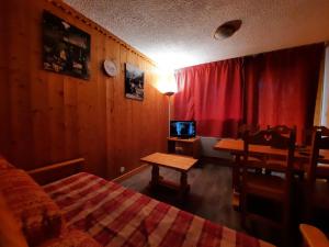 een slaapkamer met een bed, een tafel en een bureau bij Appartement Les Menuires, 2 pièces, 6 personnes - FR-1-452-97 in Les Menuires
