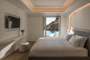 Postel nebo postele na pokoji v ubytování Arocaria Mykonos